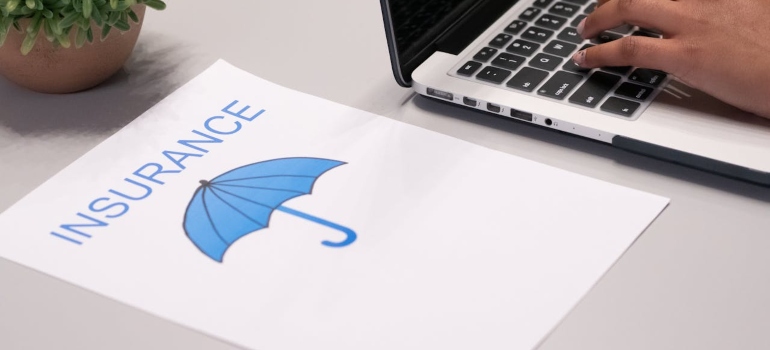 Paper next to a laptop