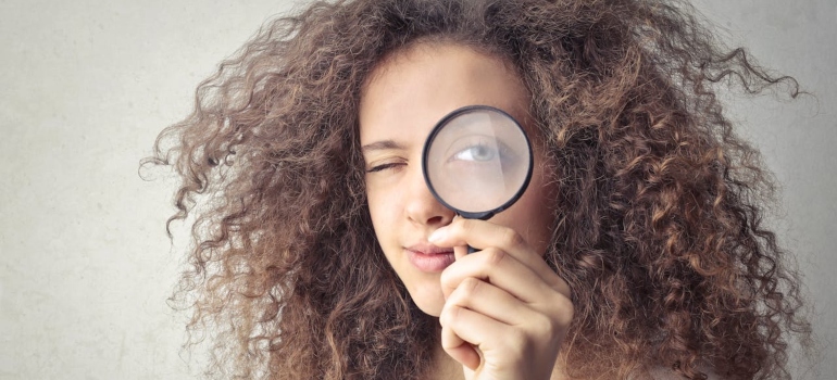Person using a magnifying glass