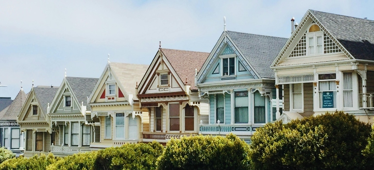 A row of colorful Victorian-style houses symbolizing residential charm in Alberta.