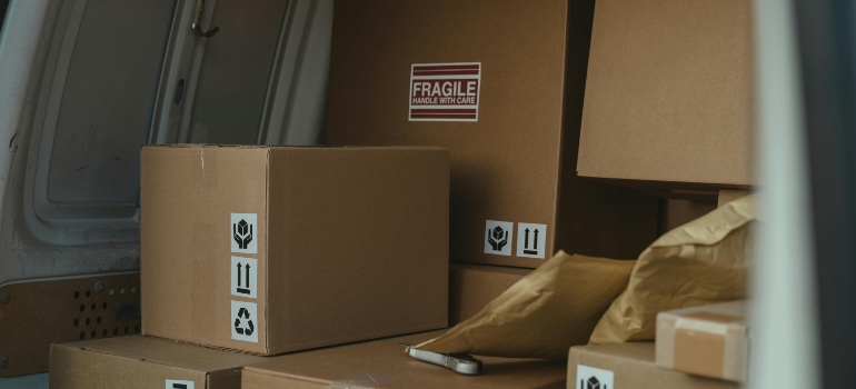 A van filled with labeled moving boxes, showcasing secure packing for relocation.