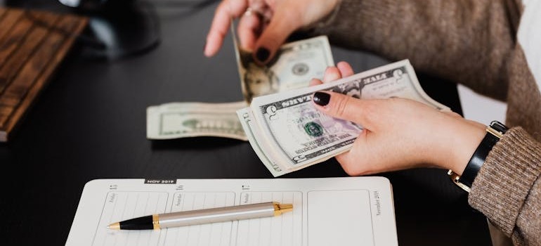 A person setting money aside after learning about the cross-province move budgeting 101s