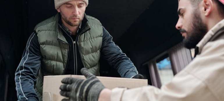 Two movers unloading a van