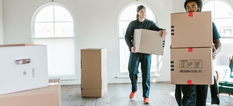 Two movers taking away boxes