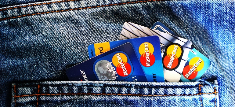 Multiple credit cards in a denim pocket—highlighting the hidden costs of moving services.