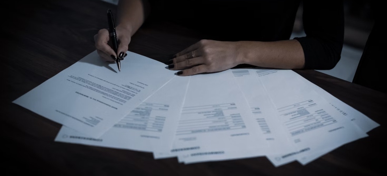 A person writing on papers