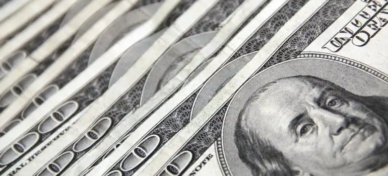 Image of 100 dollar bills symbolizing financial decisions when choosing Where do Canadians go to live in Florida?