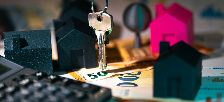 real-estate finances with keys and model houses
