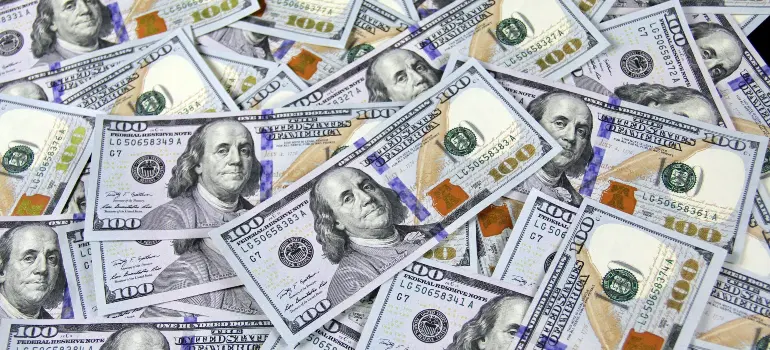 Banking differences between Canada and the US, showing hundred-dollar bills representing contrasting financial systems and currency values.