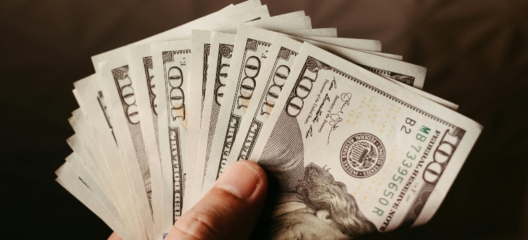 A Person Holding One Hundred Dollar Bills