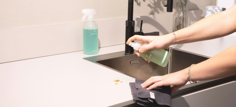 Person cleaning around a sink