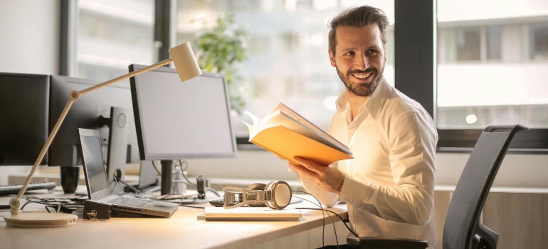 a boy in the office happy for moving to the US for work