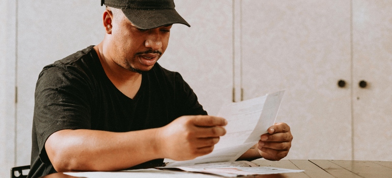 Man reviewing personal documents before embarking on a long-distance move to the USA
