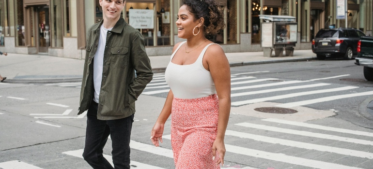 a boy and a girl crossing the street