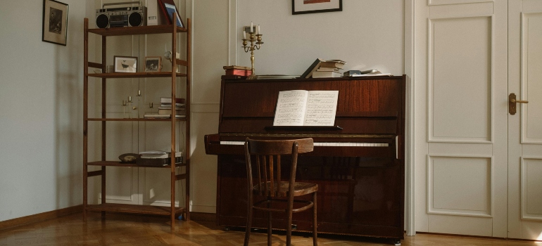 A wooden piano in a living room.