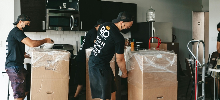 Moving crew arriving at a home with a moving truck and boxes