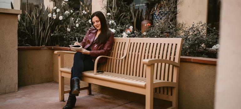 a girl writing something on the paper