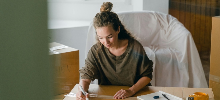 a girl writing about money-saving tips for your move