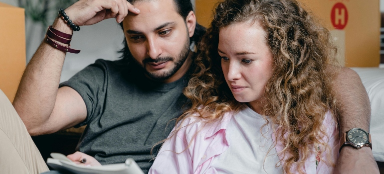 a girl and a boy writing something about money-saving tips for your move