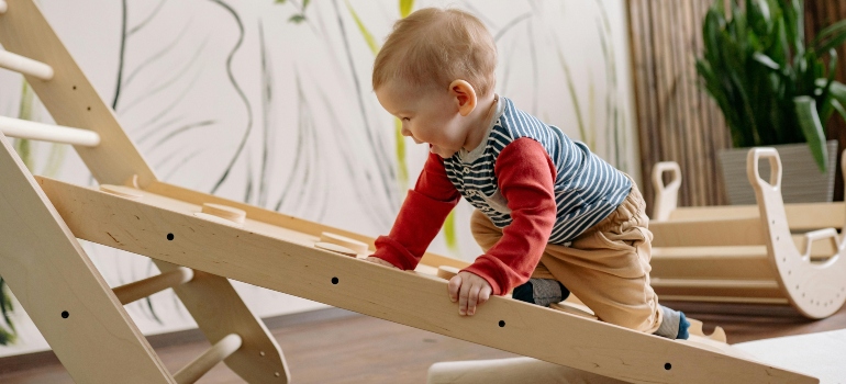 a baby climbing the ladder