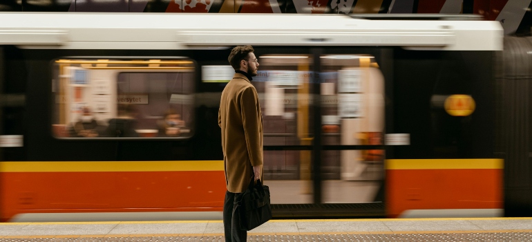 a boy waiting for the train thinking about money-saving tips for your move