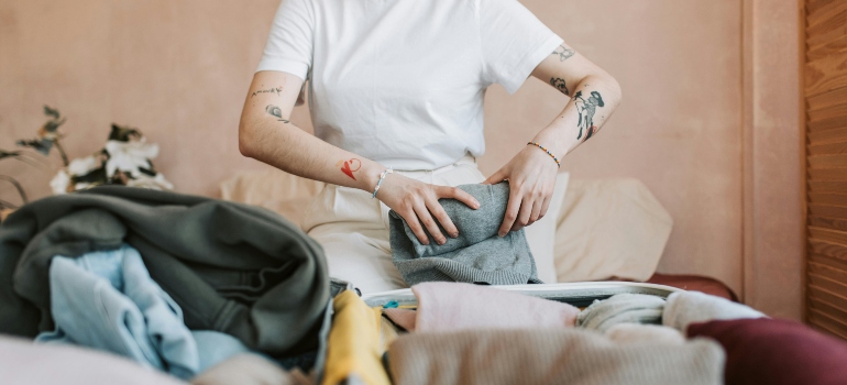 a girl packing essential packing tips on the bed