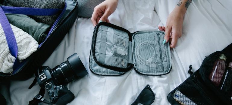 a girl packing the camera in the bag