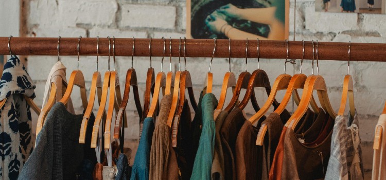 Sorting through clothes before moving, separating items into keep, donate, and discard piles.