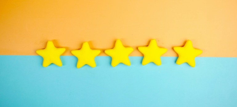 Yellow stars on a colorful background representing customer reviews and trust, linked to tips on what can you do when your movers are late.