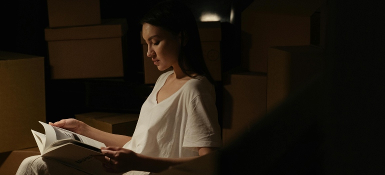 a girl reading about labelling containers for relocation