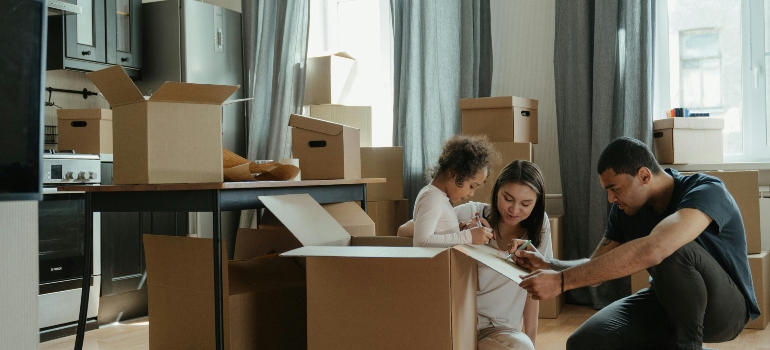 the family preparing for labelling containers for relocation