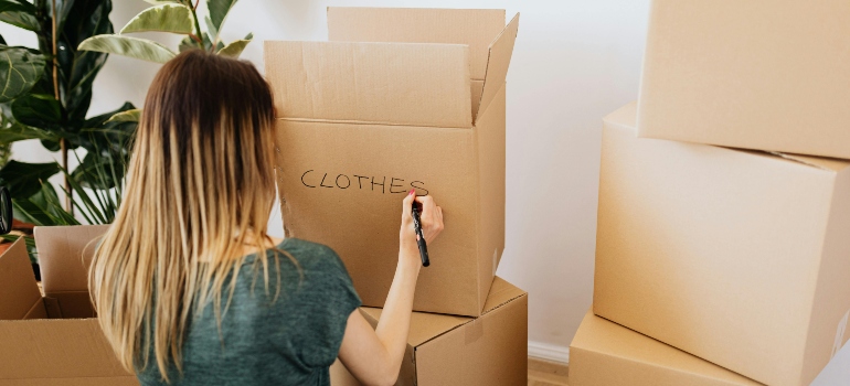 a girl packing things in the box