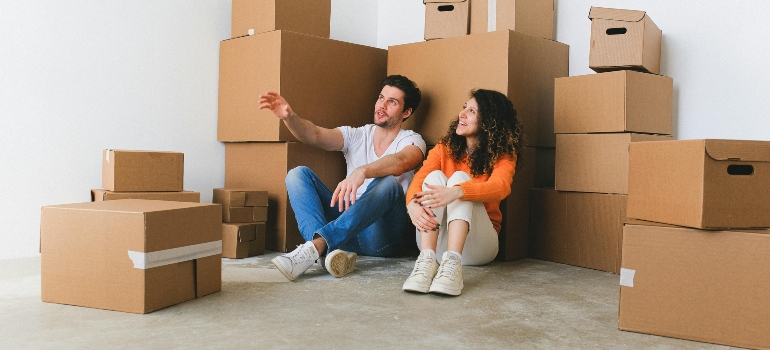 boy and girl talking about labelling containers for relocation