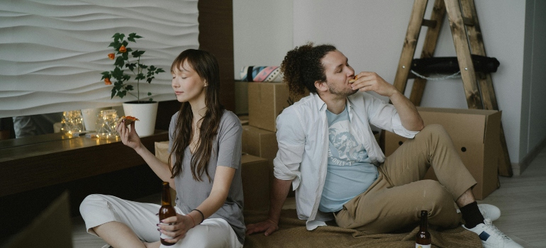 a boy and girl sitting on the floor