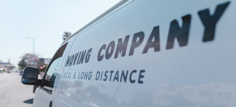 Close-up of a sticker on a car indicating a long-distance move, symbolizing preparation for relocation across regions.
