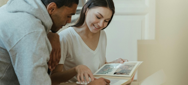 Woman in White Tank Top Sitting Beside Man in Gray Hoodie