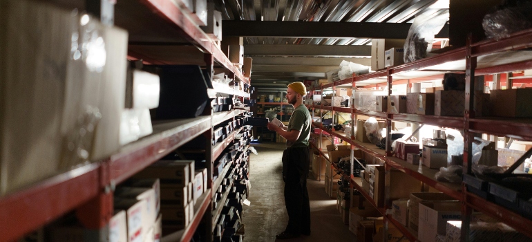 A Man Standing Inside the Warehouse