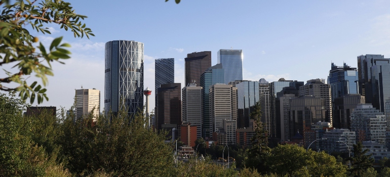City buildings under a clear blue sky as families prepare for relocating from Calgary to Vaughan