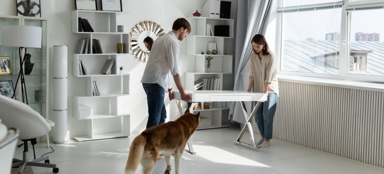 People lifting a table