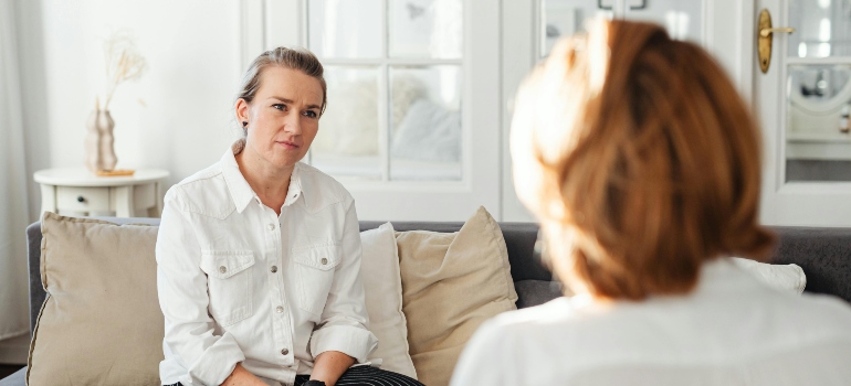 Two Women Sitting and Talking at Home