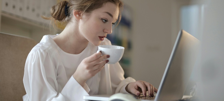 Woman In White Long Sleeve Holding A Mug