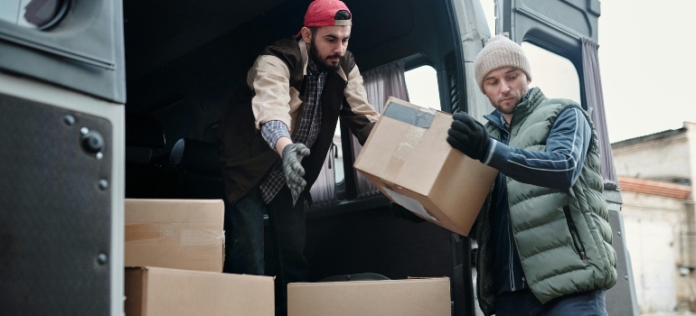 Men Taking Boxes out of Van