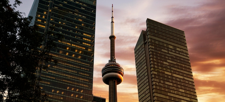 CN Tower and surrounding office towers representing commercial districts involved in business relocation planning.
