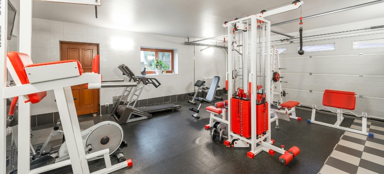 Home gym with weight machines and equipment that require secure packing during relocation.