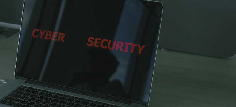 Laptop displaying cybersecurity message to highlight data protection during temporary office storage during a Toronto move.