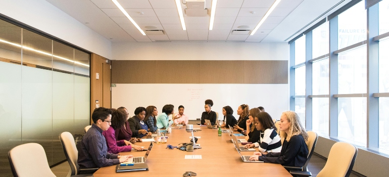 Corporate team meeting to plan secure and organized office relocation strategy.