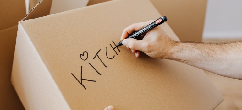 Person labeling a box