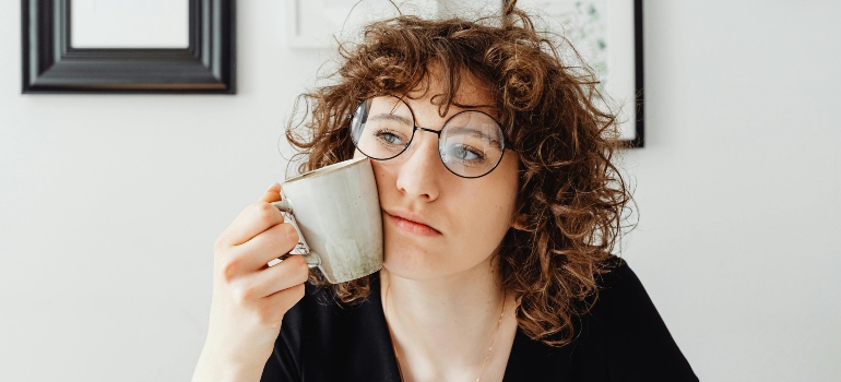 Person appearing overwhelmed while planning relocation, representing emotional challenges of moving.