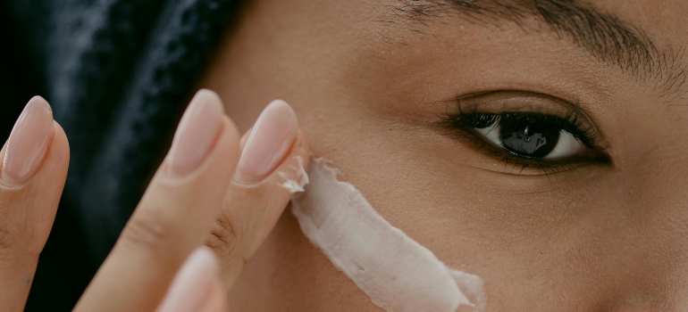 Woman applying Facial Cream on Face