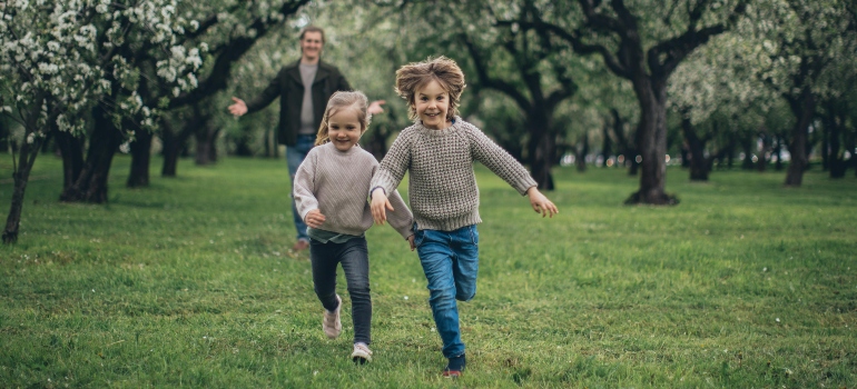 Father and Children Running in a Park