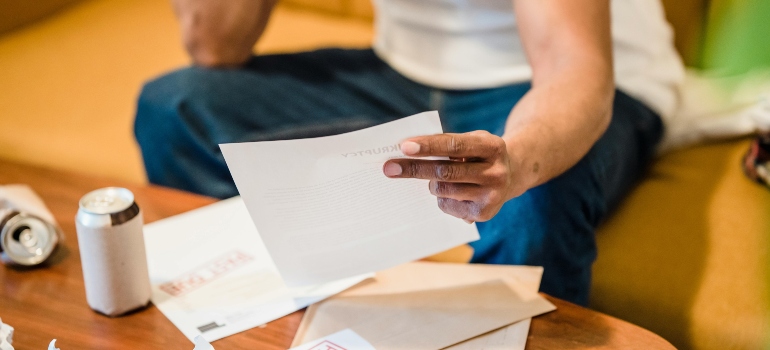 Person checking bills and paperwork after moving into a new home.